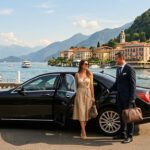Drive Milano private chauffeur opening the door of a premium luxury limousine for a client at Lake Como during summer